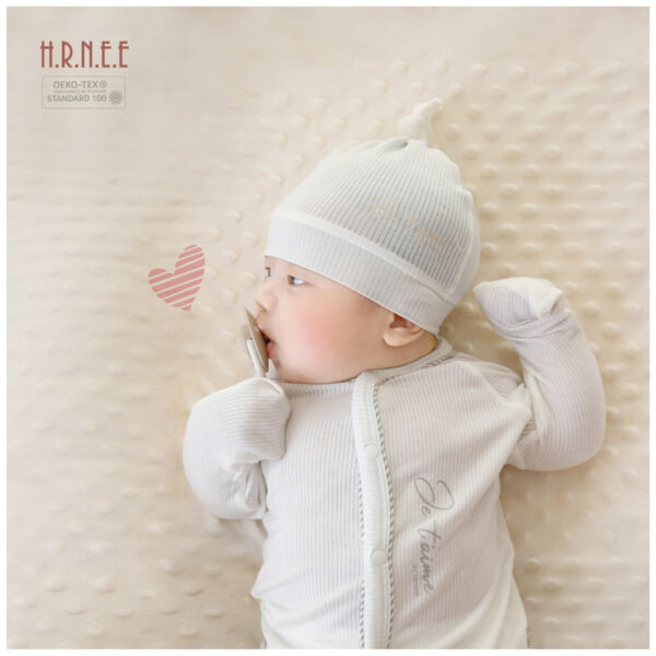 baby wearing white clothing